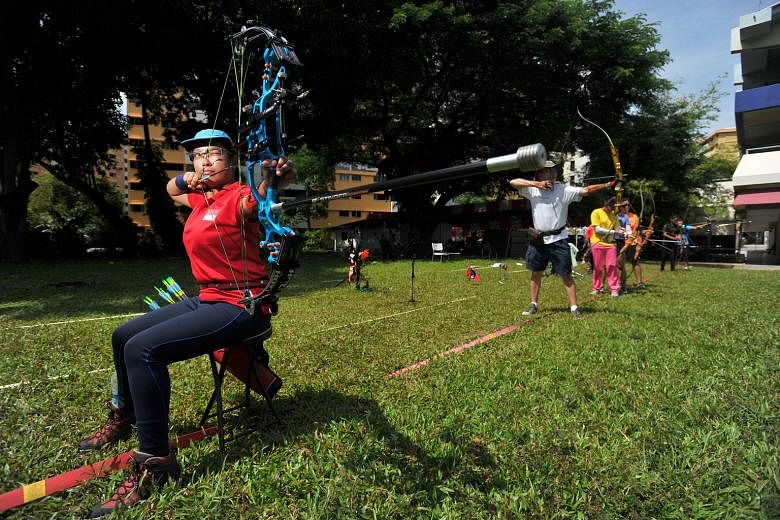 Nur Syahidah Alim, the 30-year-old Team Singapore para-archer, training at Shelton College International yesterday. She will join forces with able-bodied archers for the first time at the Singapore National Games.