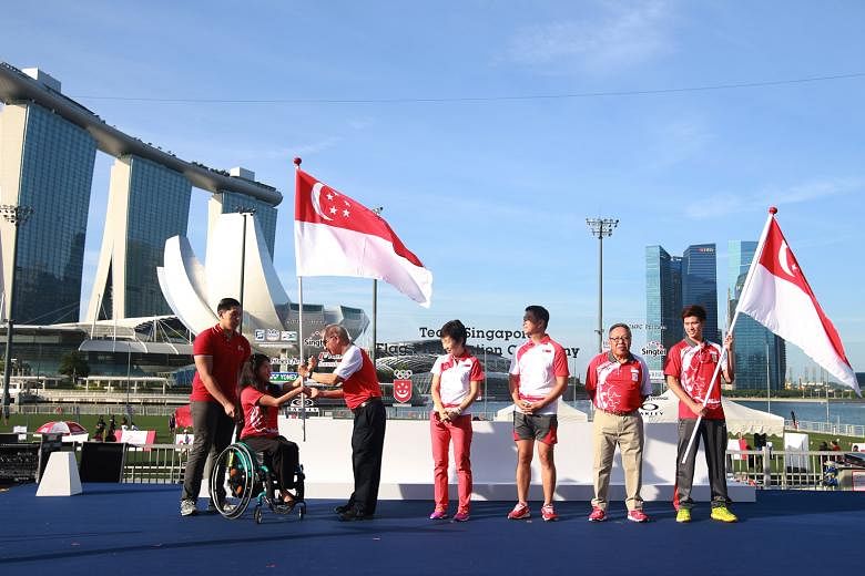 Para-swimmer Yip Pin Xiu (second from left) and shuttler Derek Wong (right), the flag-bearers for the Paralympics and Olympic Games respectively, with their chefs de mission Ho Cheng Kwee and Low Teo Ping. Minister for Culture, Community and Youth Gr