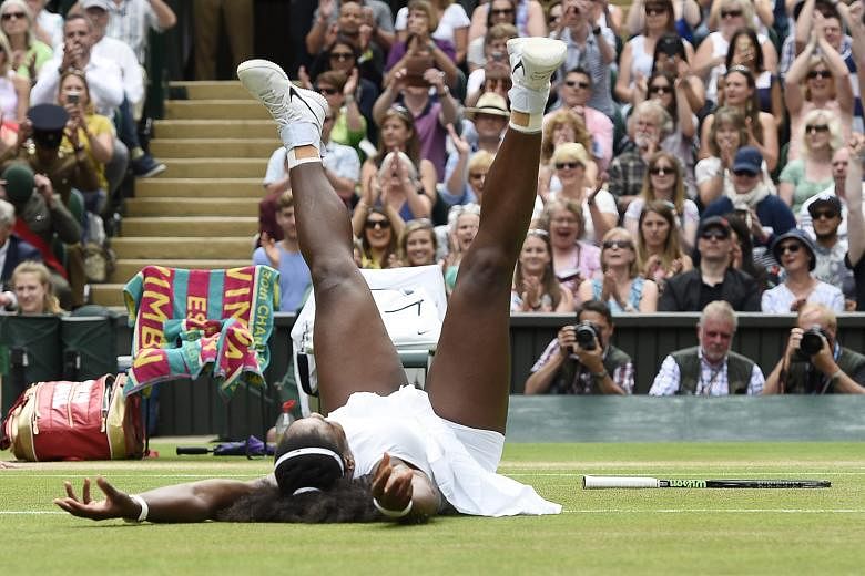 Overwhelmed by her victory, Serena Williams falls to the grass after winning 7-5, 6-3 against Angelique Kerber in the Wimbledon women's singles final.