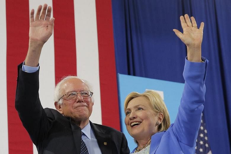 Mr Sanders and Mrs Clinton presenting a united front at Tuesday's rally in New Hampshire, a critical swing state.