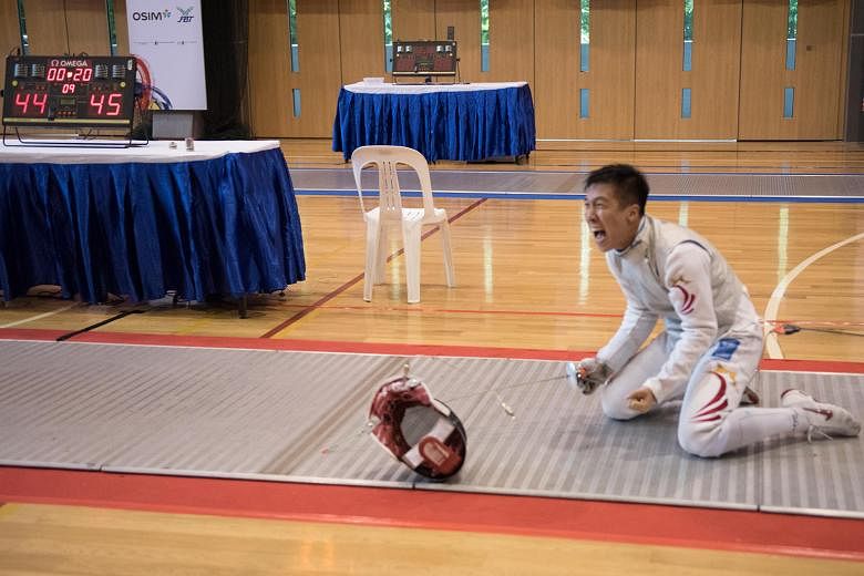 Singapore's Zhang Zhenggang after winning the last point of the closely fought men's foil team final to seal a 45-44 win for the gold medal.