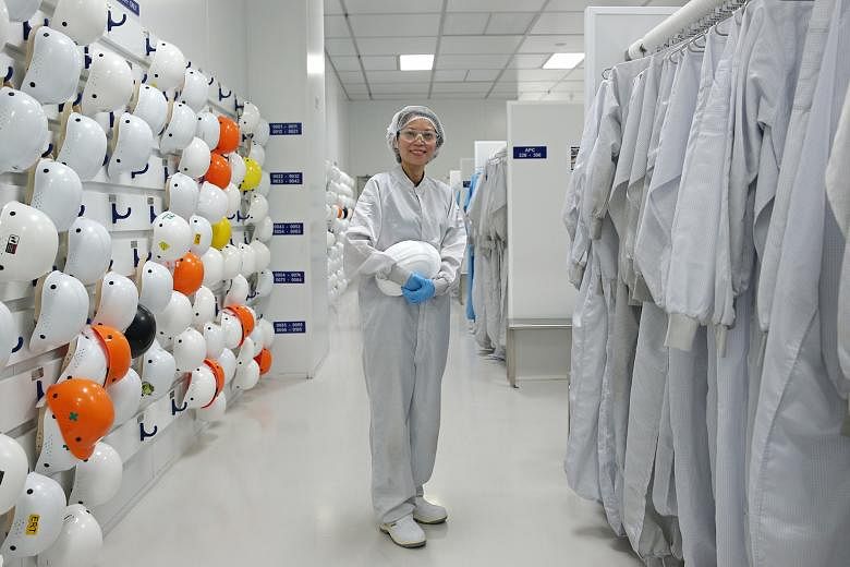 Ms Lee in the gowning area where Applied Materials workers suit up to ensure no dust contaminates the components on the factory floor. She heads a 180-strong team and is responsible for all the chemical mechanical planarization equipment that is manu