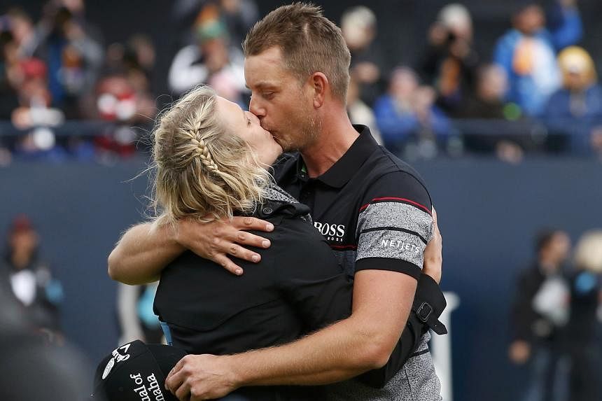 Left: Sweden's Henrik Stenson shows his delight after making birdie on the 15th hole - the second of his four in the last five holes of the final round of the British Open on Sunday. Below: Stenson with his wife Emma after sealing his first Major. Bo