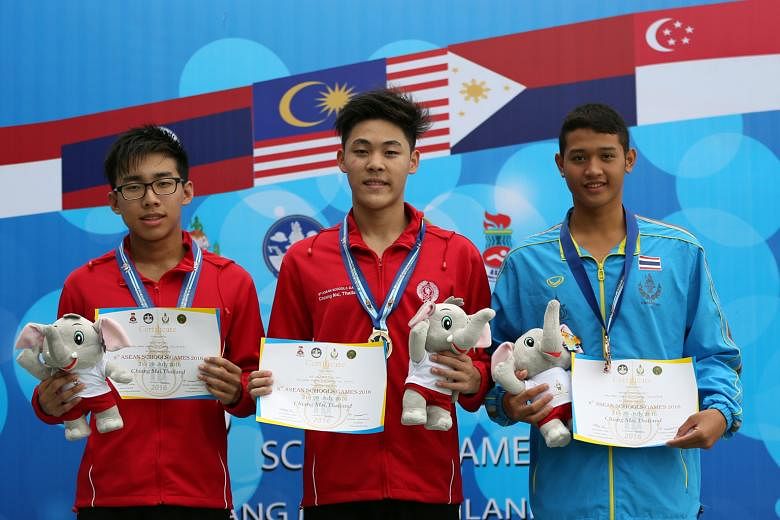 (From left) team-mates Ong Jung Yi (silver) and Maximillian Ang (gold) with Thailand's Phubert Chankeeree (bronze) after the men's 400m individual medley at the 8th Asean Schools Games in Chiang Mai yesterday.