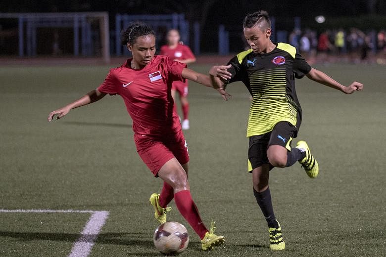 Defender Siti Rosnani Azman (left) during a friendly match last week. The Lionesses are competing in a tournament in Myanmar and will play Vietnam tomorrow.