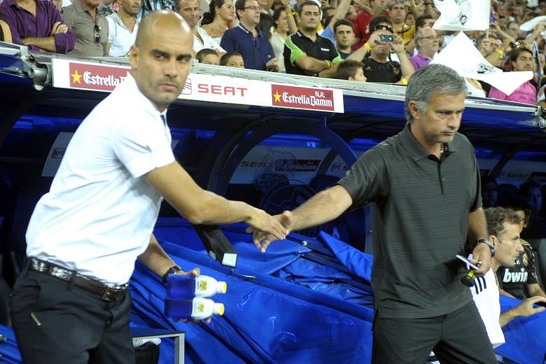 Pep Guardiola (left) and Jose Mourinho, then coaches of Barcelona and Real Madrid respectively, reluctantly greeting each other before the first leg of the Spanish Super Cup at the Bernabeu back in August 2011.