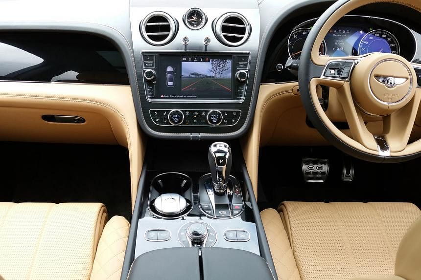 The interior is recognisably Bentley in furnishing and finishing, with all manner of gadgetry and plenty of room for both passengers and luggage.