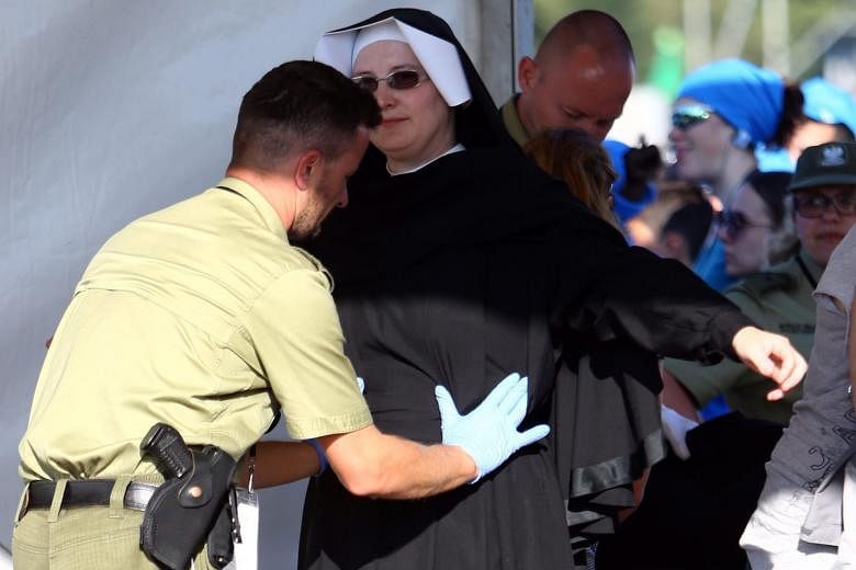A nun participating in World Youth Day 2016 undergoing a security check before the Stations of the Cross mass with Pope Francis in Blonia Park in Krakow, Poland, over the weekend. World Youth Day 2016, which is being held in Krakow and nearby Brzegi,