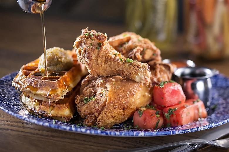 Yardbird's Llewellyn's Fried Chicken with watermelon cubes, cheddar cheese waffle and bourbon maple syrup.
