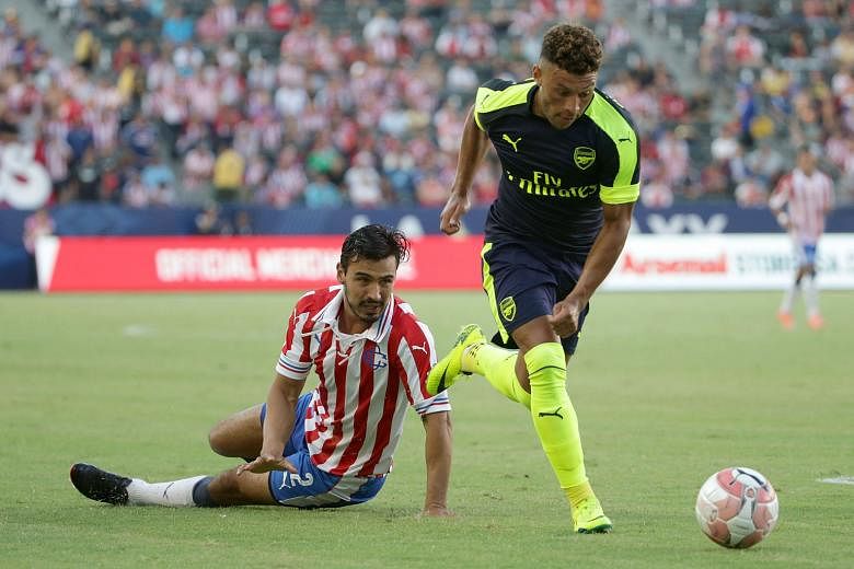 Alex Oxlade- Chamberlain of Arsenal evading Guadalajara's Oswaldo Alanis during the second half of their pre-season friendly in California. His goal in the Gunners' 3-1 victory prompted Arsene Wenger to hail his "power and penetration".