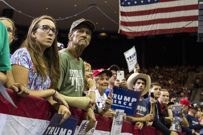 Supporters listening to Republican presidential nominee Donald Trump speak last Wednesday in Jacksonville, Florida. To working-class white Americans, Mr Trump is the one politician who actively fights elite sensibilities, whether they are good or bad