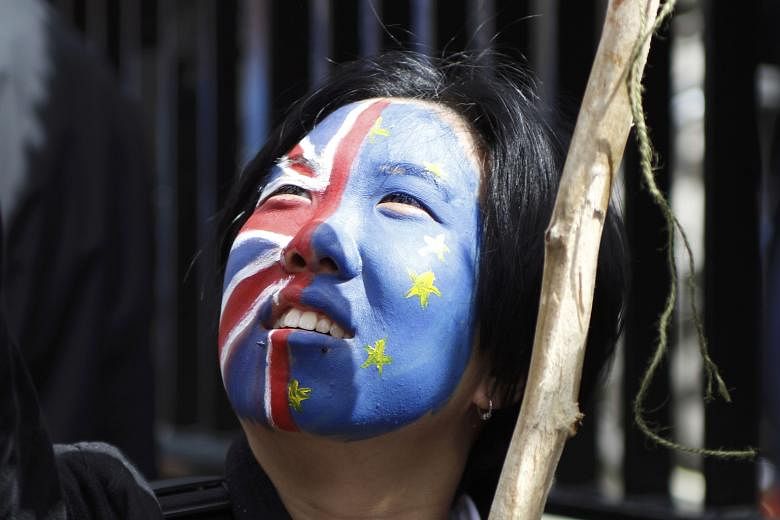 A woman at a protest march against Brexit. Britain's decision to leave the European Union has been a cause of concern for economists looking at Singapore's growth outlook.