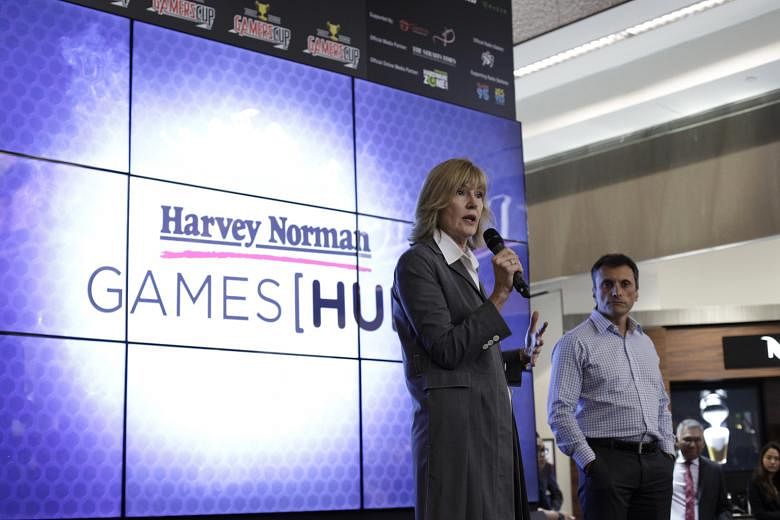 Ms Page at the launch of the Harvey Norman Games Hub, the first such gaming-focused installation by the Australian retail chain. Mr Pao (left) with a customer at the Harvey Norman Games Hub media launch last week. The HTC vice-president said his comp