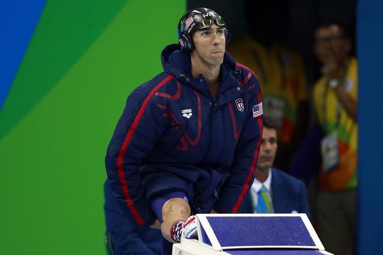 Michael Phelps wearing the US swim team's warm-up parka before the start of the men's 200m butterfly final, in which he won gold, in Rio de Janeiro.