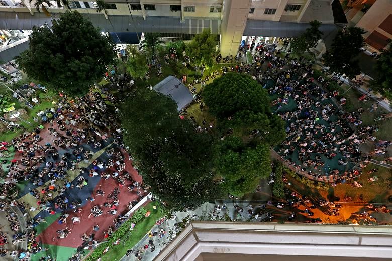 Pokemon Go players crowding in front of Block 401, Hougang Avenue 10, last Saturday. Large numbers have gathered daily at the hot spot, mainly at the amphitheatre and playground between Blocks 401 and 415, a strategic place for catching the game's vi