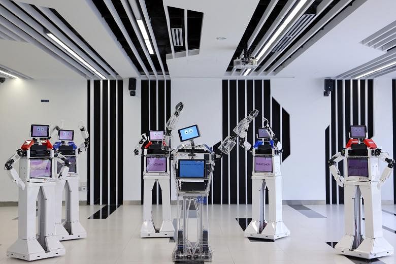 These robotic fitness coaches will get your body running like a machine. The five Robocoach 2.0 models, which surround the first-generation model (pictured at centre), are developed by Ngee Ann Polytechnic's electrical engineering division to teach e