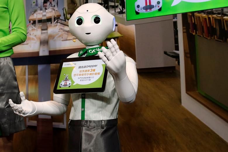 Japanese firm SoftBank's "Pepper" robot, dressed in an Asia Pacific Telecom uniform, in Taipei.