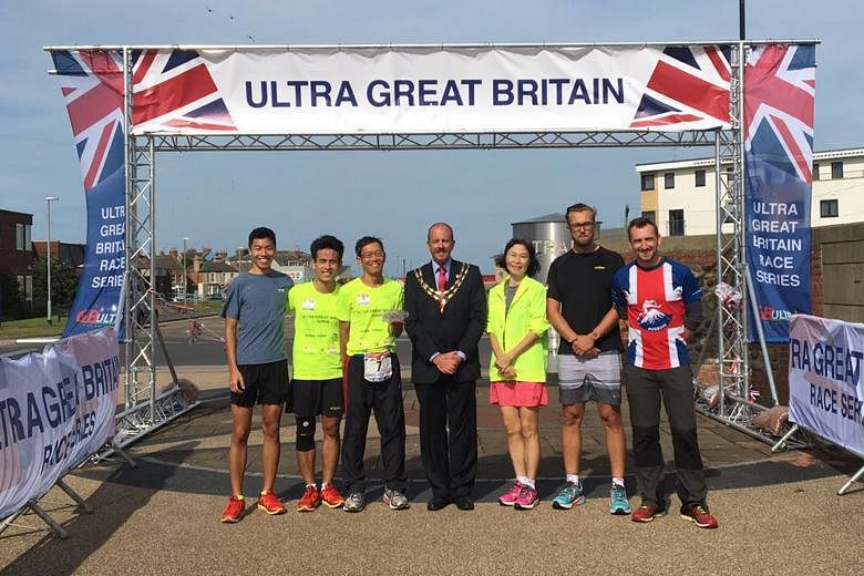 Mr Lim (third from left) at the finishing line on Tuesday with (from left) his son, Mr David Lim; his son's friend, Mr James Sng; Hornsea mayor Lee Walton; Mr Lim's wife, Ms Deborah Mok; Mr Lim's British physician, Dr Tomas Wally; and race director M