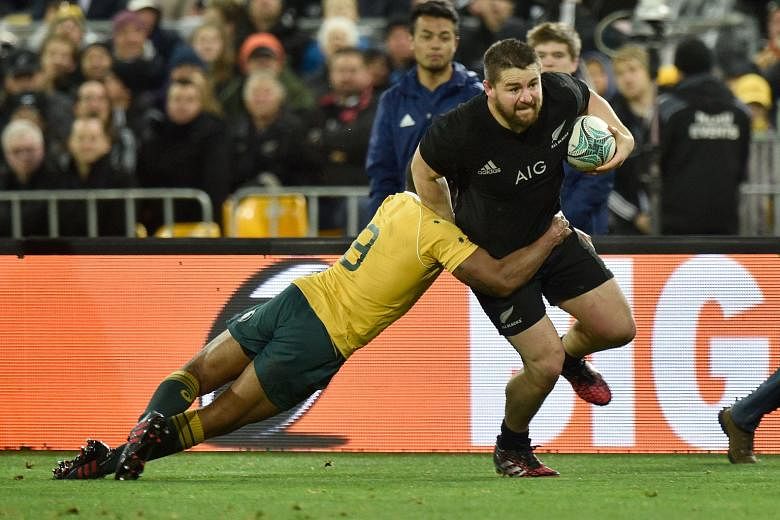 New Zealand's Dane Coles (right) being tackled by Australia's Will Genia in Wellington yesterday. The All Blacks' 29-9 win, coupled with their victory a week earlier, gave them the Bledisloe Cup for the 14th consecutive year. Australian coach Michael