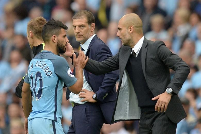Manchester City manager Pep Guardiola acknowledging Sergio Aguero after he was substituted in the 3-1 English Premier League victory over West Ham on Sunday, as Hammers boss Slaven Bilic watches on. Aguero may miss the Sept 10 Manchester derby if he 