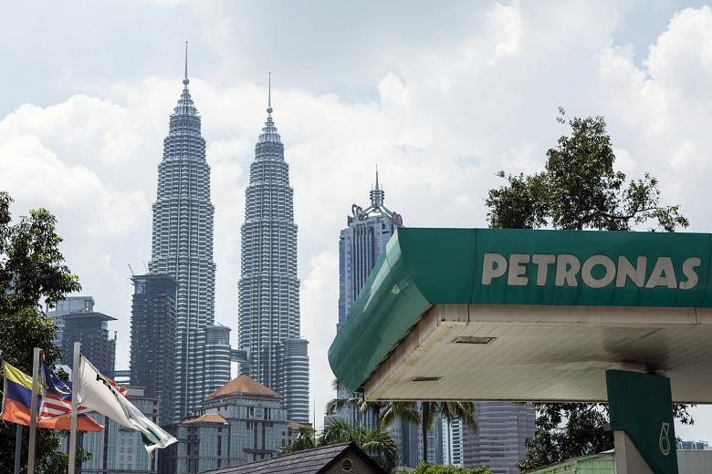 A Petronas petrol station in front of the Malaysian state oil company's flagship Petronas Twin Towers in Kuala Lumpur.