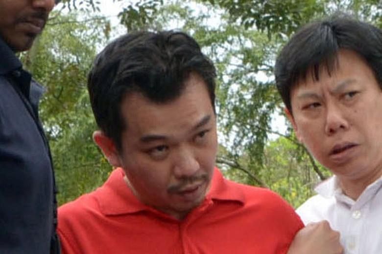 Police officers taking Lee to Sembawang Park during investigations in 2014. Lee had carried out recce trips to places he thought were good for collecting ransom cash, including Bottle Tree Village in Sembawang.