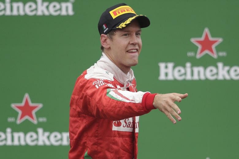 Ferrari's Sebastian Vettel celebrates third place on the podium at the Italian Grand Prix yesterday.