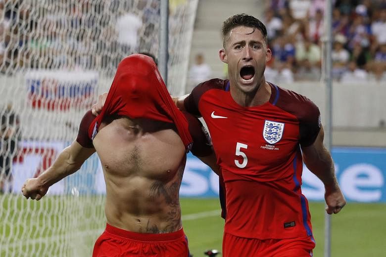 England's Adam Lallana (far left) celebrating with Gary Cahill after scoring his team's one and only goal in the 95th minute. Sam Allardyce's side prevailed over 10-man Slovakia for a winning start to England's 2018 World Cup qualifiers in Group F.