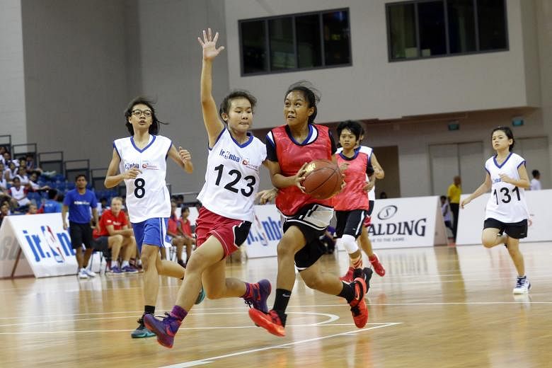 Jurong Secondary School's Valarie Lim (No. 123) showing the defensive side of her game. The 14-year-old was named girls' Most Valuable Player at the first Jr. NBA Singapore 2016 National Training Camp.