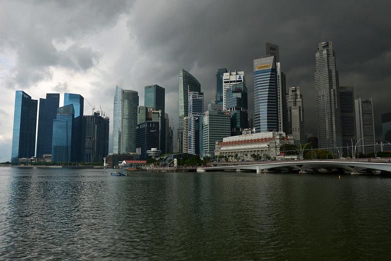 Storm clouds hover over Singapore's business and financial district. The Government recently downgraded its official projections for 2016 GDP growth from 1-3 per cent to 1-2 per cent, the lowest since the 2009 global financial crisis.