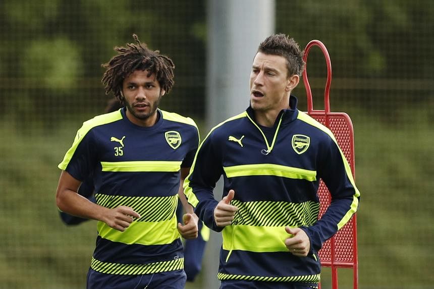 Arsenal's Laurent Koscielny and Mohamed Elneny training before their clash with French champions Paris Saint-Germain. Koscielny is troubled by an eye injury after taking a kick to his face against Southampton.