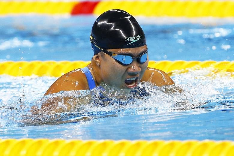 Above: Theresa Goh battling her way to a bronze in the 100m breaststroke SB4 final at the Olympics Aquatics Stadium in Rio. Left: Yip Pin Xiu and Goh shedding tears of joy together after the latter's swim.