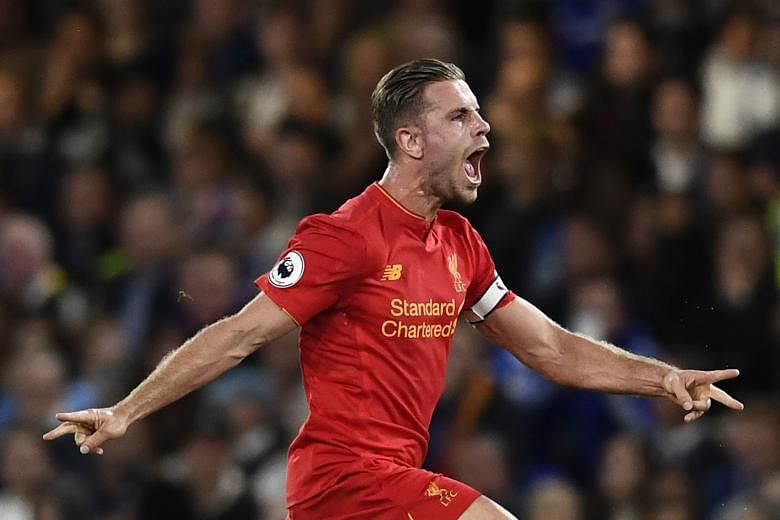 Liverpool captain Jordan Henderson celebrates scoring Liverpool's second goal at Stamford Bridge on Friday. The visitors beat Chelsea 2-1, adding to key victories against Arsenal and reigning champions Leicester City this season.