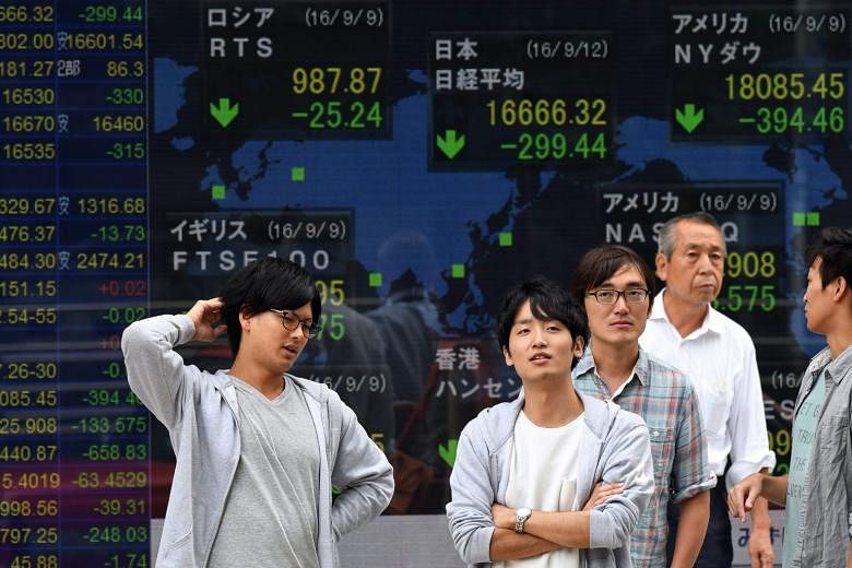 A monitor showing stock market indices in Tokyo last week. Speculation over whether the US Federal Reserve will raise interest rates and uncertainty over the Bank of Japan's monetary policy have roiled regional equities.