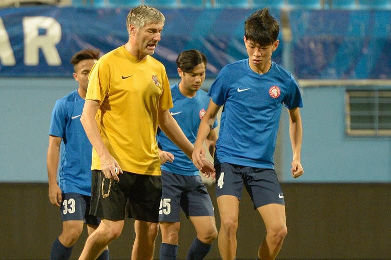 Young Lions coach Patrick Hesse giving instructions to Joshua Pereira (front) during a training session yesterday. The Young Lions, who are sitting bottom of the S-League table, will face sixth-placed Hougang United tonight at the Jalan Besar Stadium