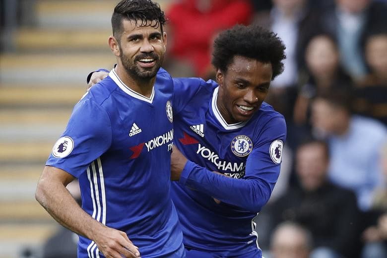 Chelsea striker Diego Costa celebrates scoring the visitors' second goal against Hull City in the 67th minute with team-mate Willian. Willian fired the Blues in front in the 61st minute of the Premier League game.