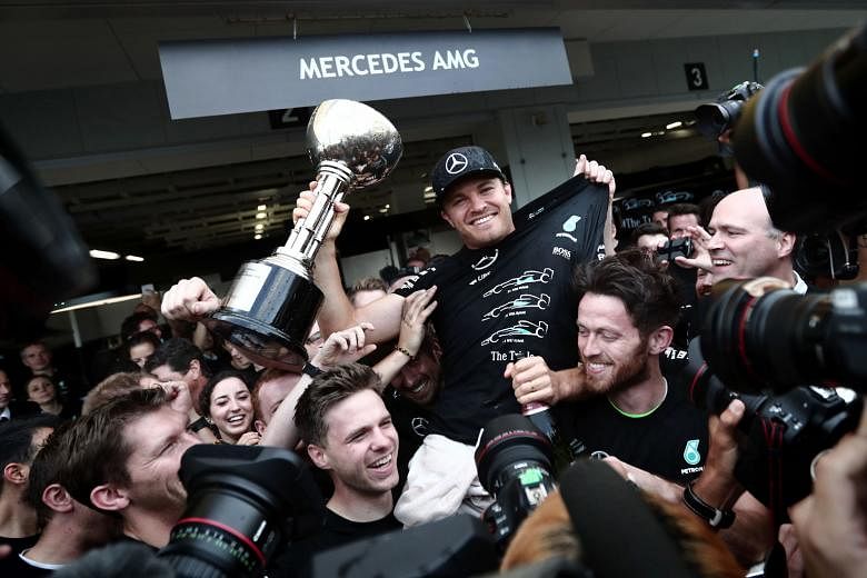 Japanese Grand Prix winner Nico Rosberg being hoisted by his team-mates, as Mercedes celebrated a third straight constructors' championship with four races to go.