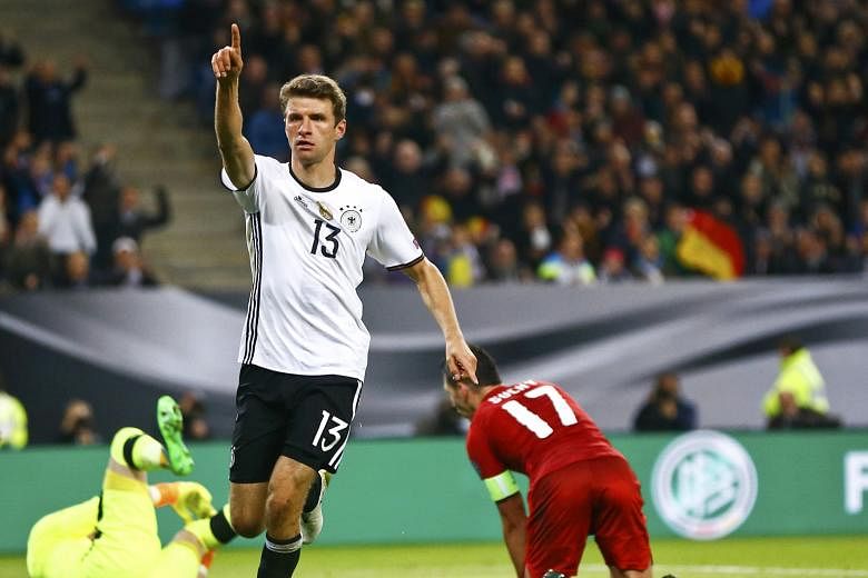 Thomas Muller signals to the crowd after scoring against the Czechs. Coach Joachim Low sees Northern Ireland as even more cautious.