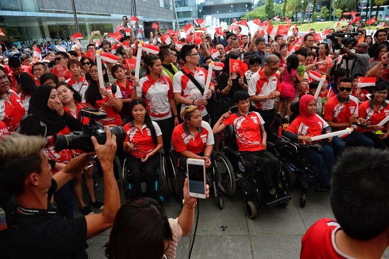 (Seated, from left) Paralympic swimmers Yip Pin Xiu and Theresa Goh, boccia players Toh Sze Ning and Nurulasyiqah Taha, track and field athlete Suhairi Suhani and archer Nur Syahidah Alim at the One Team Singapore celebratory parade last month. The e