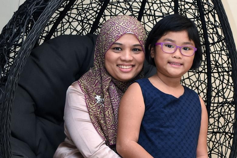 Left: Madam Noorliza, 43, a cervical cancer survivor. Above: With her daughter Farah Amirah Look Wei-En, now nine.