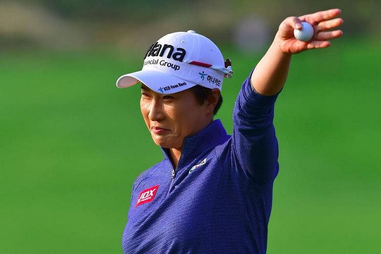 South Korean golf legend Pak Se Ri waving to the crowd at the 18th hole of the Sky72 Golf Club in Incheon. Her first round at the LPGA KEB Hana Bank Championship marked the last of her career.