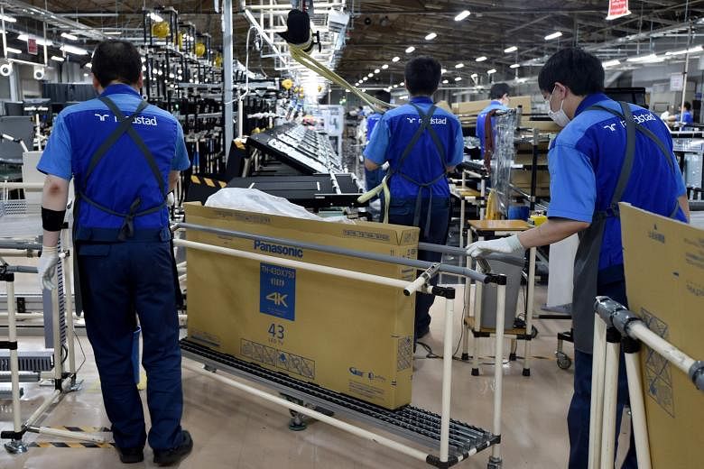 Workers at a plant in Utsunomiya, some 100km north of Tokyo, which assembles TV sets for Panasonic. Japan's exports fell 6.9 per cent last month from a year earlier, following a 9.6 per cent decline in August.
