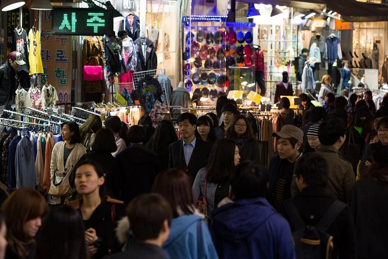 A shopping district in Seoul. What worries policymakers in South Korea is that many of those starting small businesses do so after being laid off and often lack business skills while trying to make ends meet and save for retirement. Only 30 per cent 