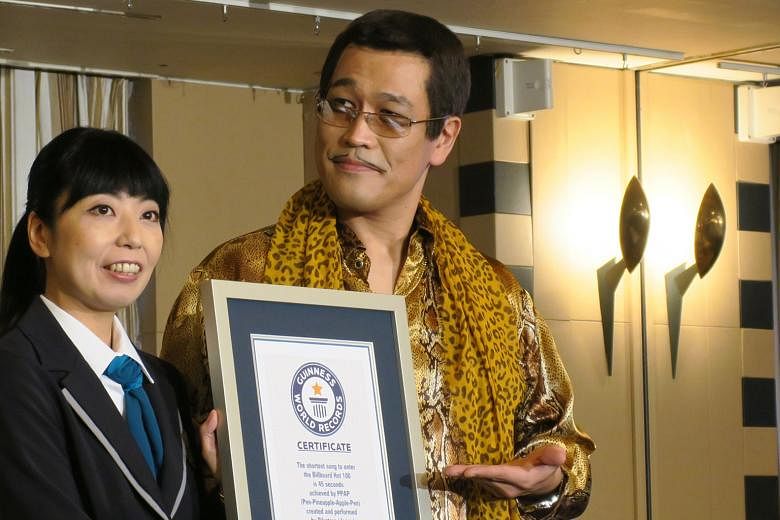 Japanese singer Piko-Taro receiving the Guinness World Record for the shortest song to chart on the US Billboard Hot 100 charts, set by his viral ditty PPAP.
