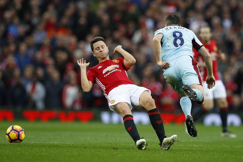 Manchester United's Ander Herrera appears to slip as he makes a challenge on Burnley's Dean Marney, but is controversially sent off. The Premier League match finished goal-less.