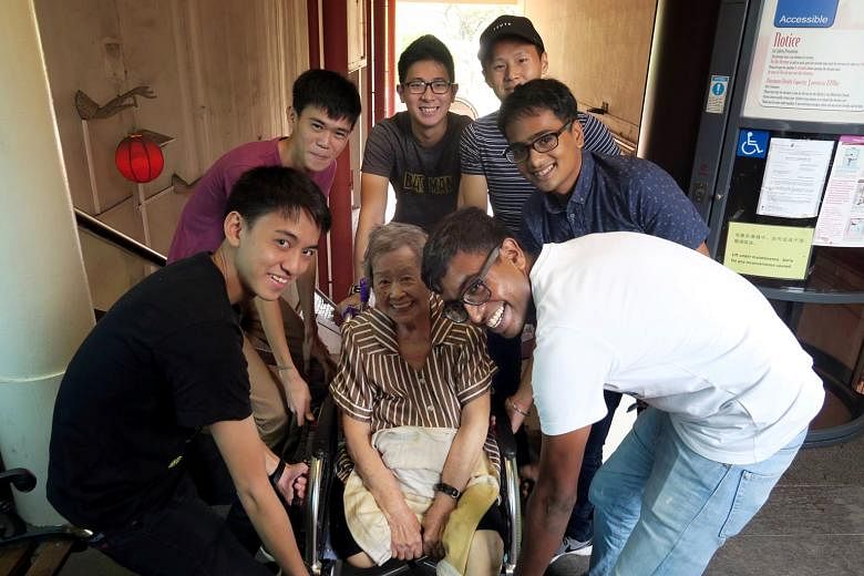 Giving Madam Loh's mother-in-law a lift up the stairs to the restaurant are (from left) Lance Cpl Wong, Pte Ng, Pte Ko, Lance Cpl Teo, 3SG Singh and MSG Johan.