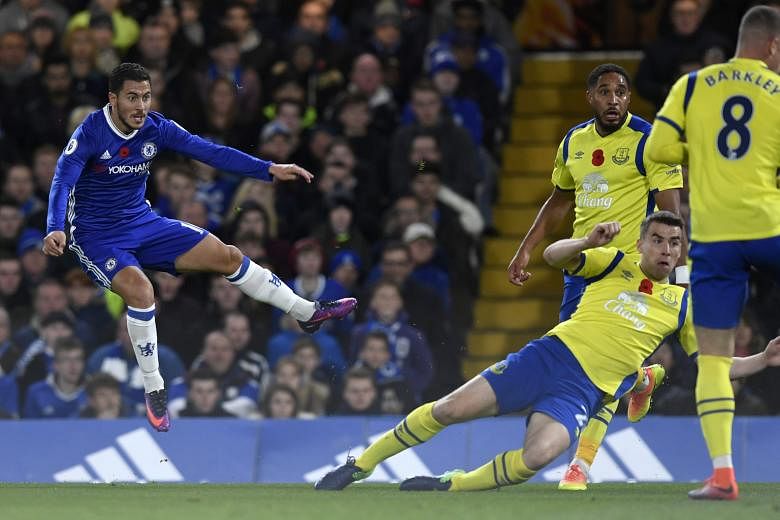 Chelsea's Eden Hazard (left) scoring the first of his two goals during the 5-0 victory against Everton on Saturday. "Eden is fantastic with the ball and he is fantastic without the ball," said Antonio Conte after the match.