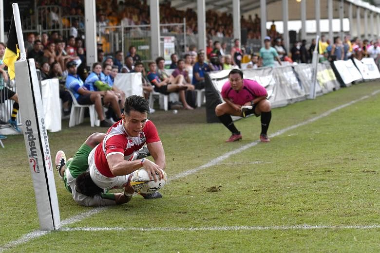 England Academy's Callum Sirker, 18, evading the challenge of Sunnybank's Junior Laloifi while attempting a try en route to a 40-21 victory in the final of the SCC International Rugby Sevens tournament.