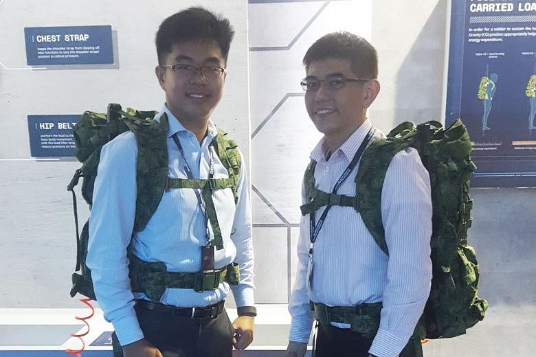 DSO technical staff Yee Qing Xiang (at left) and Cheong Chee Hoong wearing the newly developed A-Lite Pack at the SGDefence exhibition at Marina Bay Sands last week.