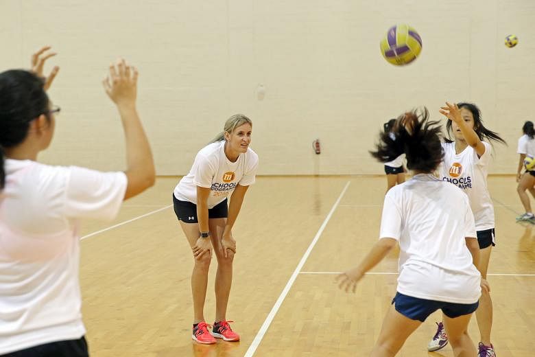 Leana de Bruin, the New Zealand two-time Commonwealth Games netball gold medallist, conducting an hour-long clinic for 24 local student-players at the OCBC Arena yesterday. She put them through different passing drills during the session, which was p